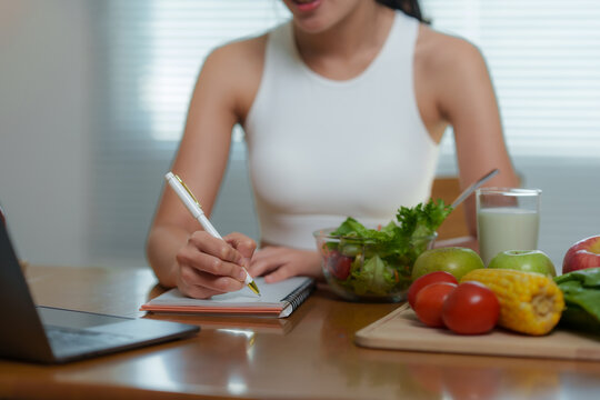 Nutritionist is writing a personalized diet plan for her client, considering healthy food like fruits, vegetables, and a glass of milk, promoting a balanced lifestyle