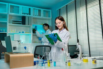 Asian male and female scientis work together in the research laboratory. 