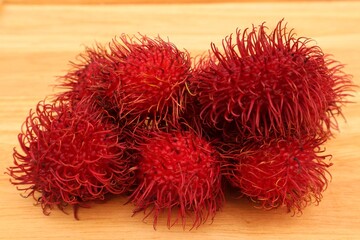 Rambutan fruit (Nephelium lappaceum L) in close view, isolated on dark background.
