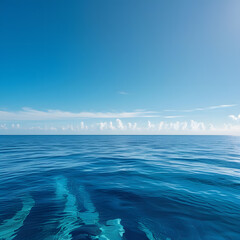 Immerse yourself in the timeless beauty of the ocean under a clear sky. This stunning image captures the deep blue waters stretching endlessly to the horizon