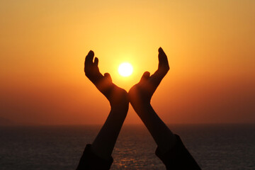 Men holding the sun in their hands