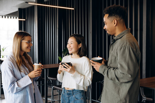 Diverse business team enjoying coffee break in modern office