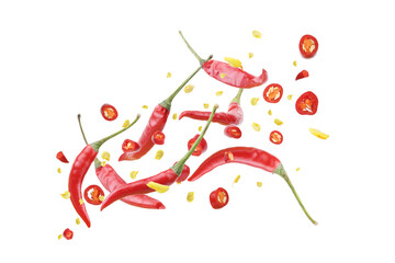 Fresh red chili peppers tossed up, isolated on a white background.