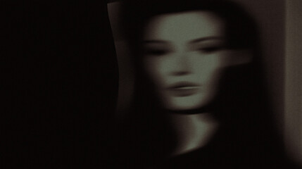 Mysterious abstract portrait of a blurred female face in low light artistic style