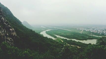 Serene River Valley Panorama: A Misty Mountaintop View