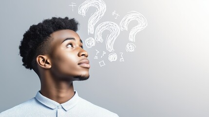 Young man looking up at drawn question marks. Concept of curiosity, problem-solving, and exploration.
