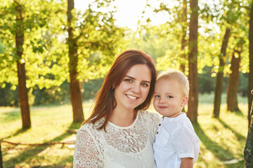 Autumn family walk in forest. Happy mother and baby boy. Family with little son in autumn park. Family and mother's day. Children Protection Day. Family picnic