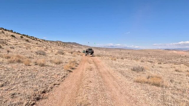 Recreation road mountain desert valley follow UTV Utah . Off road trail riding in 4x4 all terrain vehicle for sport and recreation. Desert landscape, dusty trails and recreation areas. Southwest Utah