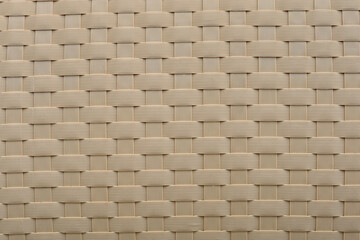 A detailed view of a textured plastic surface, featuring interwoven patterns and subtle shadows