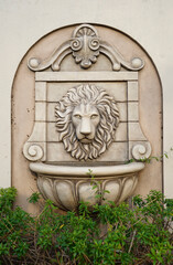 Primrose. Stone Effect King Lion Head Fountain Outdoor Wall. Ancient lion's head fountain