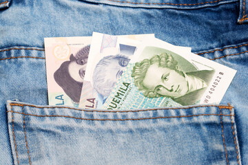 Italian Lira in the pocket of blue jeans