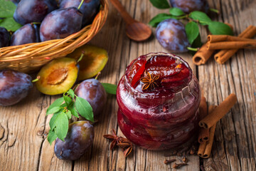 Homemade damson plum jam in blue ceramic bowl and berries