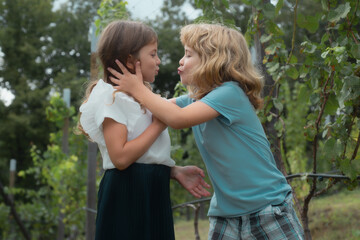 Two children outdoors. Portrait of adorable brother and sister smile and laugh together. Happy lifestyle kids.