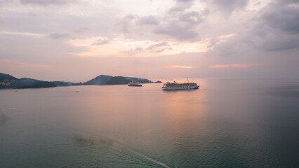 Aerial view, drone flying over Phuket city, Thailand. Drone over Patong Beach on Sunday in Phuket and tourists shopping at a street full of local merchants selling food, people resting by the sea.