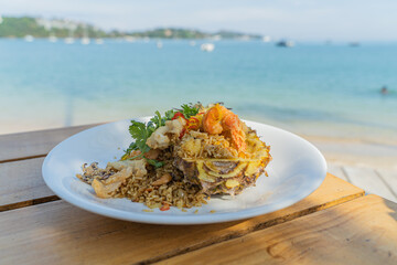 Seafood fried rice in pineapple, appetizing in a cafe next to the sea, Sue Flamingo, Ao Yon Beach, Phuket Thailand