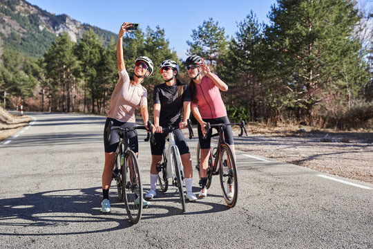 Group of women posing for a selfie during a cycling trip - Powered by Adobe