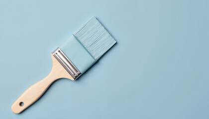 Paint brush with Benjamin Moore's universal blue shade on backdrop, creativity