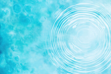 Rain droplets creating concentric ripples on a vibrant turquoise water surface
