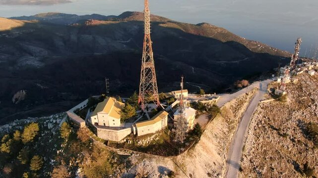 Comunication antenna on mountain. Drone flies around powerful antenna on Mount Pantokrator. Corfu, Greece.