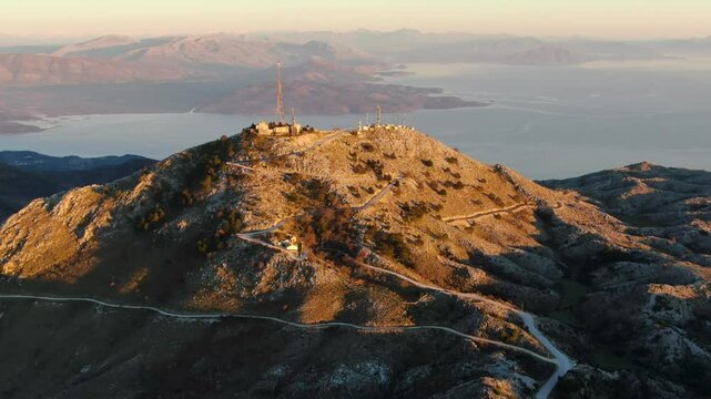 Comunication antenna on mountain. Drone flies around powerful antenna on Mount Pantokrator. Corfu, Greece.