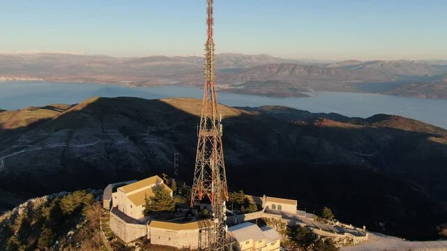 Comunication antenna on mountain. Drone flies around powerful antenna on Mount Pantokrator. Corfu, Greece.