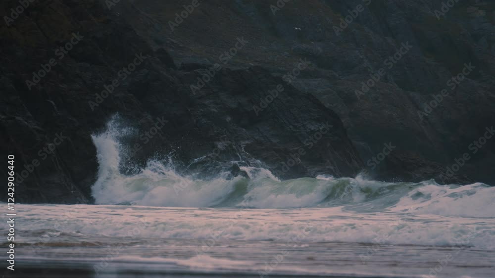 Poster powerful waves arriving on gower coast smashing into weathered jagged sea rocks in slow motion with 