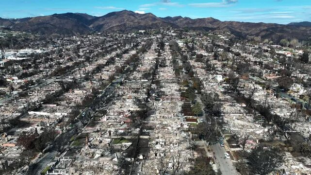 Aerial view flying over the burned Pacific Palisades area, fire aftermath in LA