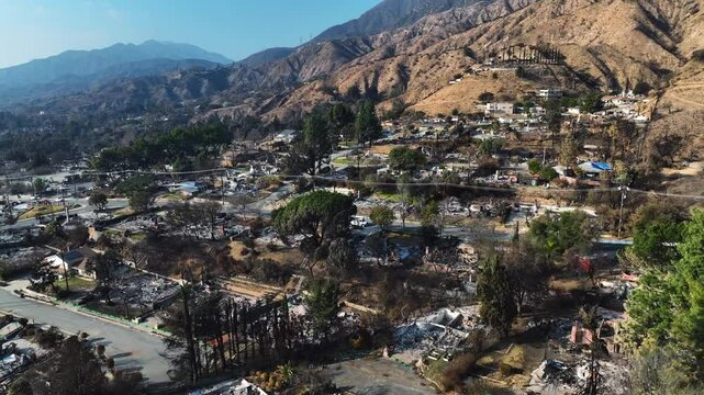 Drone following a car driving through a fire devastation area in Altadena, LA