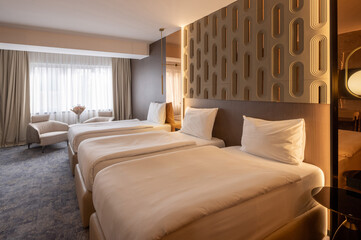Interior of a luxury three bed hotel bedroom with wooden wall decoration