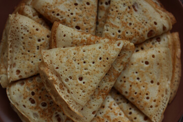 baked pancakes openwork in a hole triangles close-up