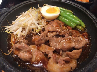 beef Yakiniku served with bean sprouts, sweet beans and boiled eggs on a hot black plate, Gyudon, Bangkok Thailand