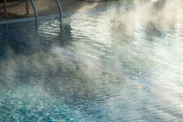 Detail of hotel outdoor pool with hot mineral water vapors