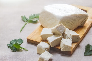 Slices of tofu made from soybeans on a cutting board