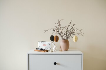 Chic minimalist easter decor features dry branches with craft eggs elegantly arranged in a simple...