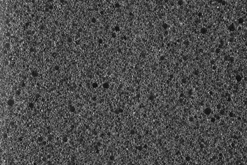 dark gray background, photo shows texture of gray foam sponge close-up