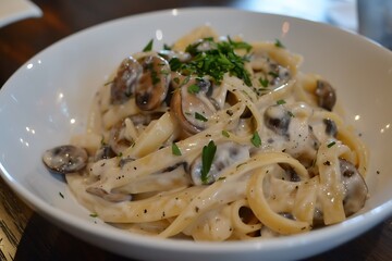 A dish of wild mushroom pasta with fettuccine in a creamy garlic sauce, garnished with freshly chopped parsley.