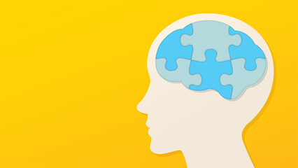 青いパズルのピースでできた脳と横顔のイラスト　黄色い背景