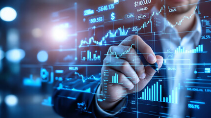 Man Writing on Transparent Glass Table with Stock Market Graphs and Financial Data in Futuristic Office Setting Ideal for Business, Finance, and Technology Content