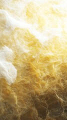 An abstract texture featuring soft, golden fibers intertwined with hints of white, creating a warm and ethereal appearance.