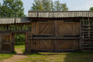 Wooden gates made of logs in the village of Bogoslovka