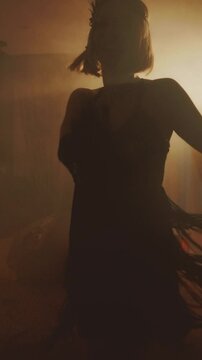 Old film style dark female silhouette dancing sexy vintage dress fringe waving. retro young happy woman dancer at night club party have fun. Charleston dance in night room full smoke vertical screen