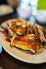 Grilled chicken chopped in a plate. Thai street food