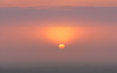Sunset over a distant hazy horizon