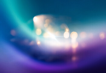 Abstract gradient background in shades of blue, purple, and teal. The background is grainy and has a subtle shimmer.