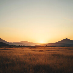 expansive hinterland scene with mountains in the distance and a golden sunrise over a grassy plain, creating a sense of vast space and tranquility