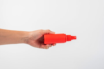 Cosmetic red bottle and hand, bottle spay, lotion or serum on white background.