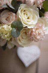 wedding bridal bouquet in boho, rustic style. bouquet of soft pink roses, eustomas and eucalyptus branches