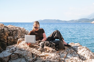 Work,Remotely work.freelancer works remotely home.cozy workation, remote work,leisure, work life balance,digital nomad, workation,work travel,remotely work.Travelling.Work vacation remotely