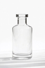 Clear long diffuser bottle with seamless texture against a bright backdrop showcasing minimalist design
