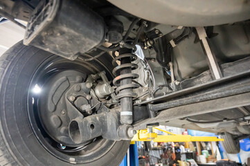 Shock spring under a car tire. 